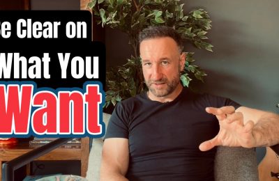 Andy Holt seated in a home setting, gesturing while speaking, with overlaid text reading “Be Clear on What You Want.”